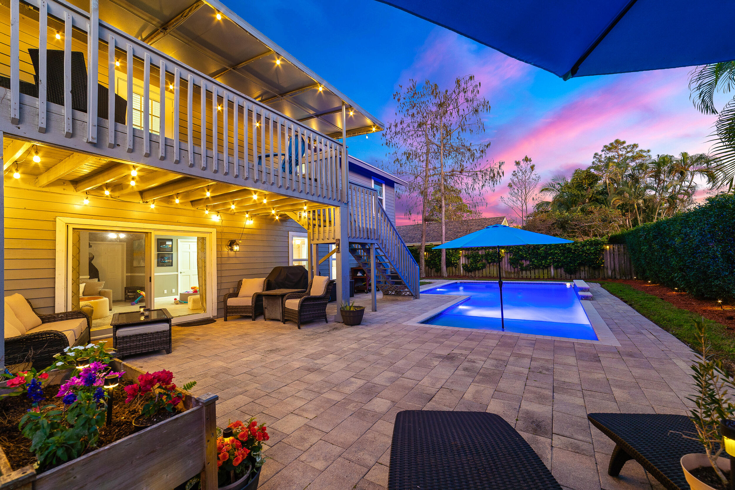 1045 Raintree Lane Wellington, FL 33414 - Photo 34 of 43 a view of a patio with furniture and a yard