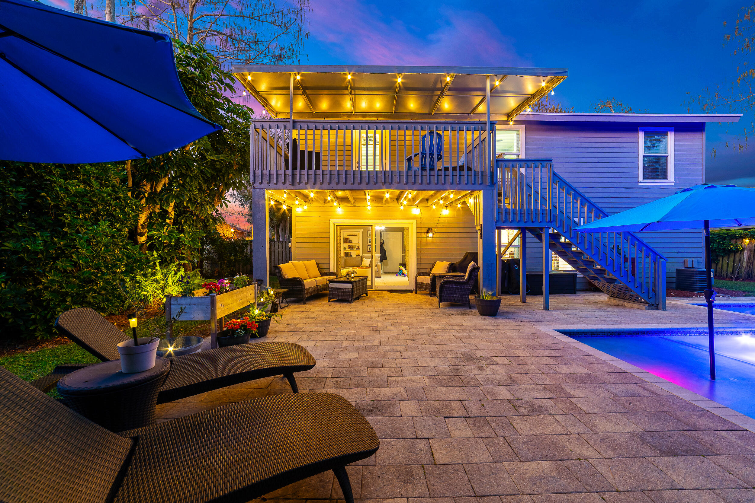 1045 Raintree Lane Wellington, FL 33414 - Photo 36 of 43 a view of a patio with a table and chairs under an umbrella