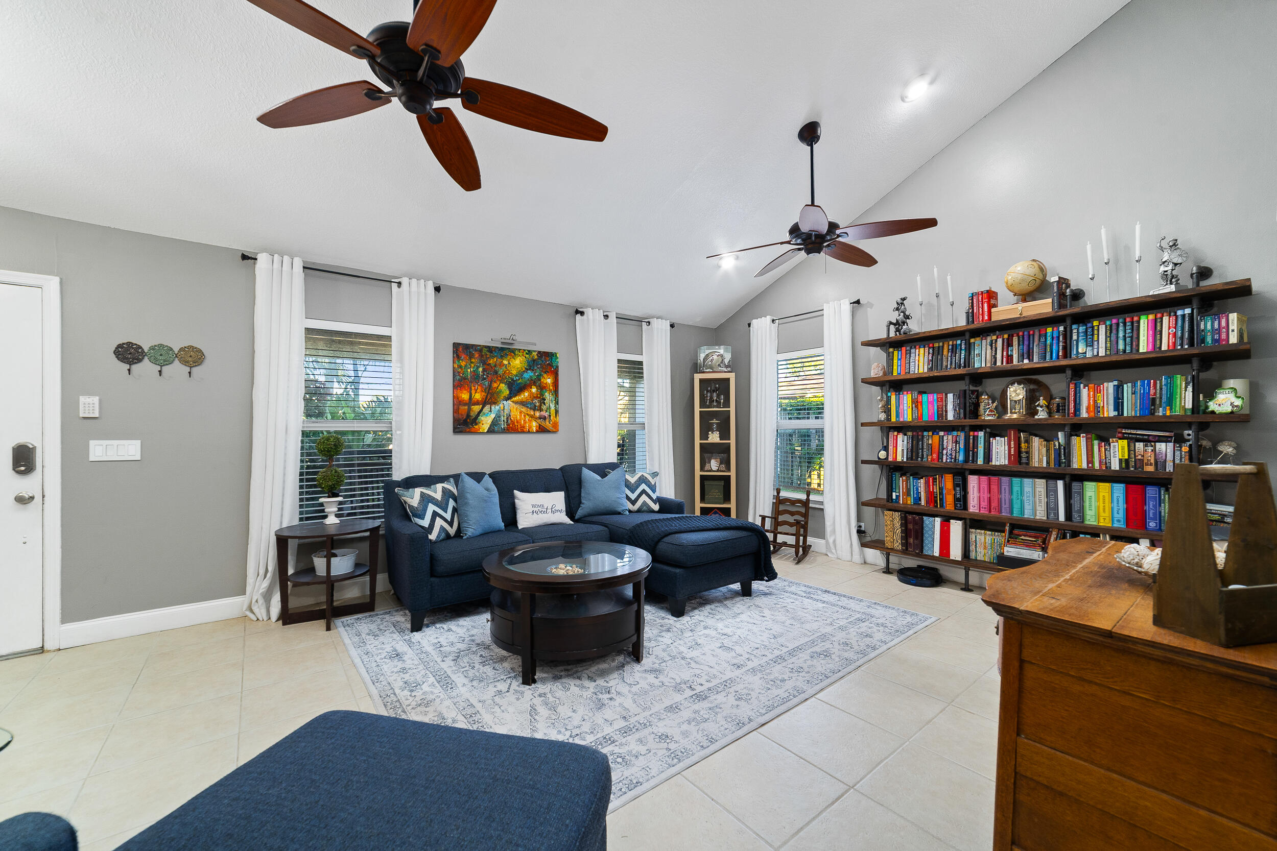 1045 Raintree Lane Wellington, FL 33414 - Photo 4 of 43 a living room with furniture and a book shelf