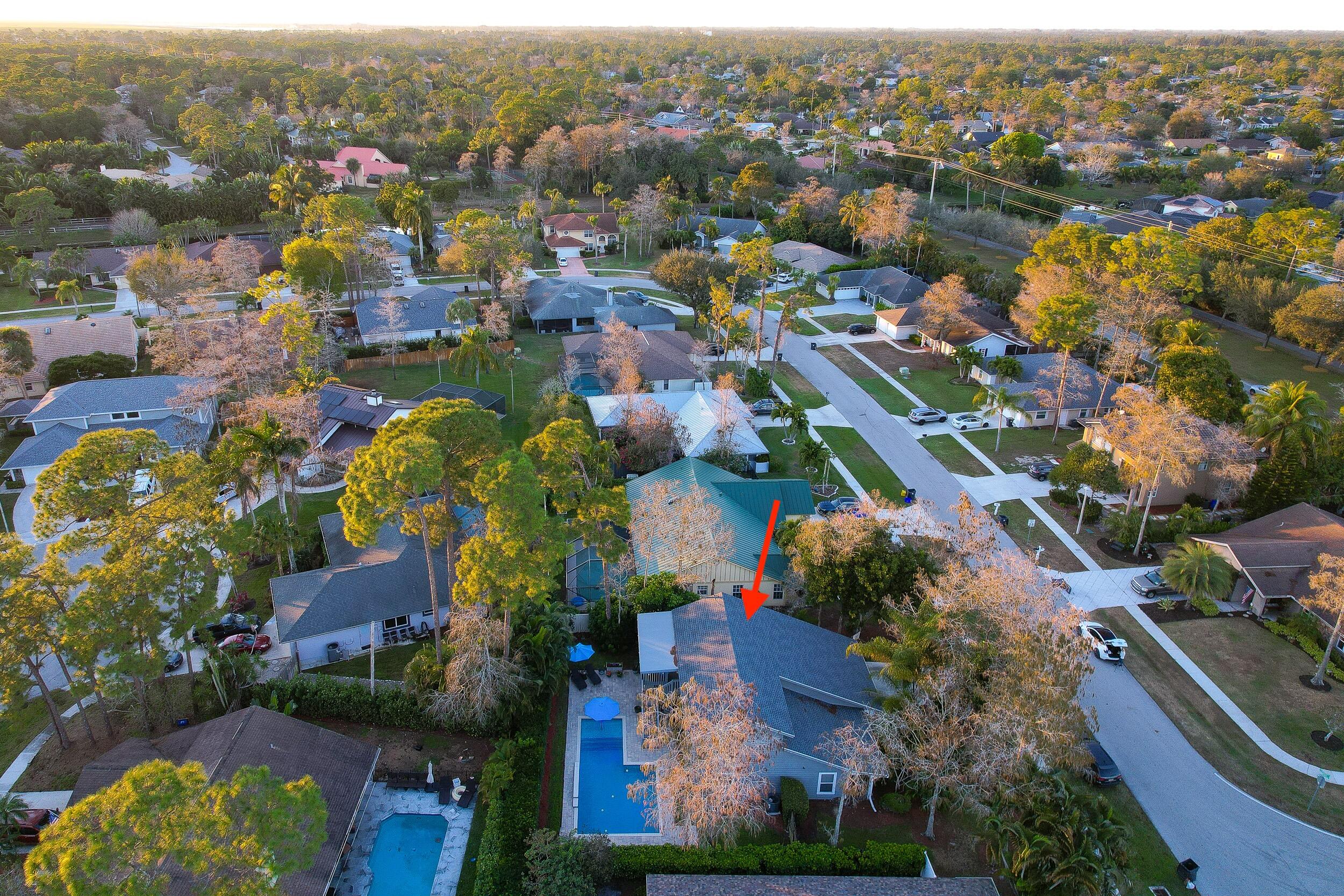 1045 Raintree Lane Wellington, FL 33414 - Photo 42 of 43 an aerial view of lake and residential houses with outdoor space