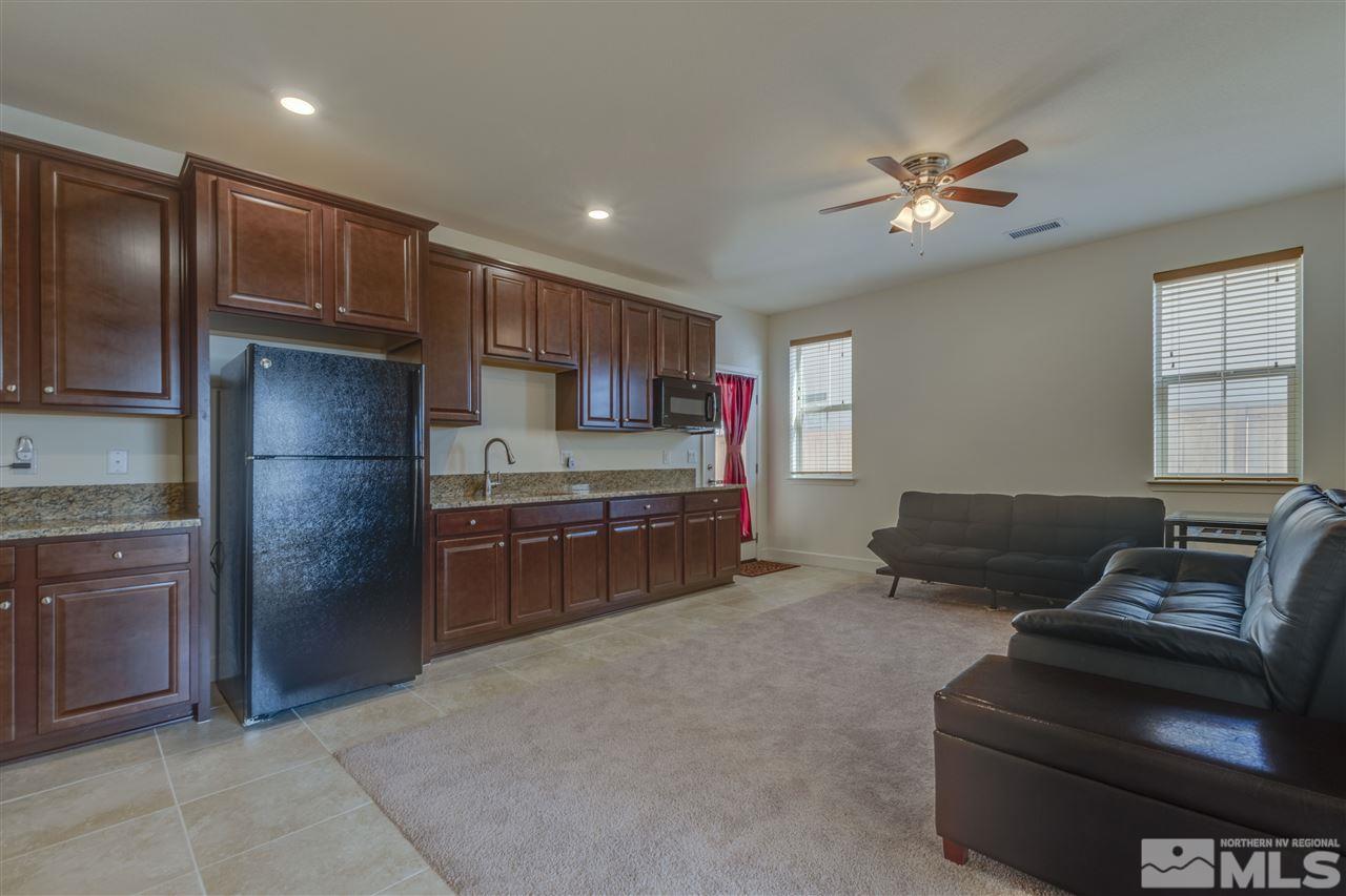 8845 Winter Peace Court Reno, NV 89523 - Photo 3 of 23 a kitchen with stainless steel appliances granite countertop a refrigerator and a stove top oven