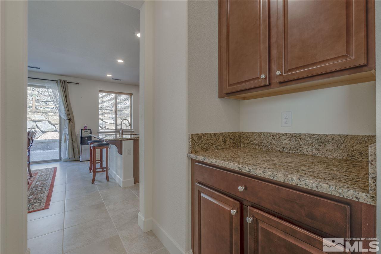 8845 Winter Peace Court Reno, NV 89523 - Photo 8 of 23 a kitchen with stainless steel appliances granite countertop a stove and a sink