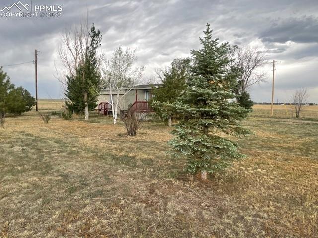 9456 McClelland Road Calhan, CO 80808 - Photo 15 of 31 a backyard of a house with table and chairs