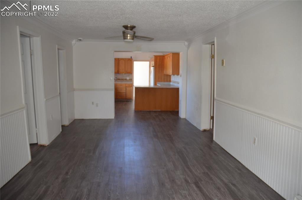 9456 McClelland Road Calhan, CO 80808 - Photo 7 of 31 a view of an empty room with wooden floor and a window