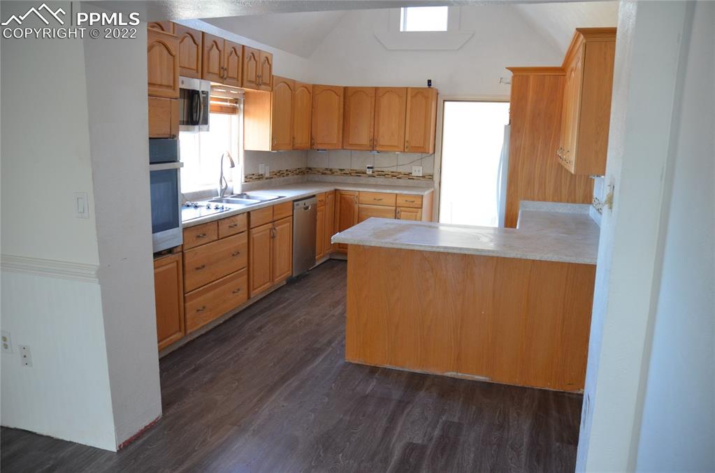 9456 McClelland Road Calhan, CO 80808 - Photo 8 of 31 a kitchen with wooden floors and sink