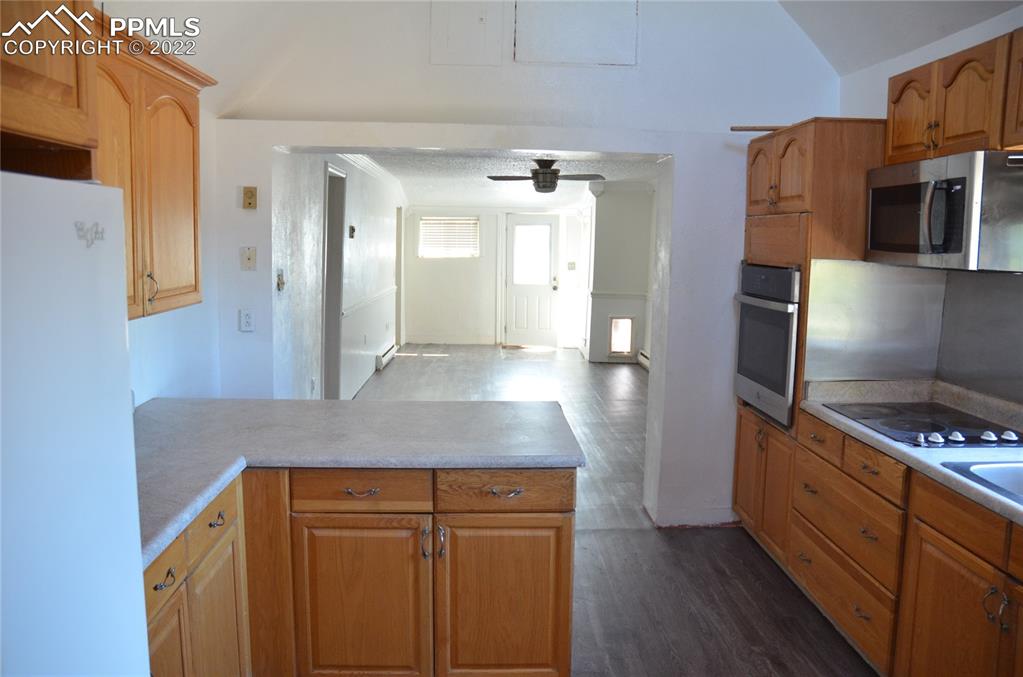 9456 McClelland Road Calhan, CO 80808 - Photo 9 of 31 a kitchen with stainless steel appliances granite countertop a refrigerator and a stove top oven