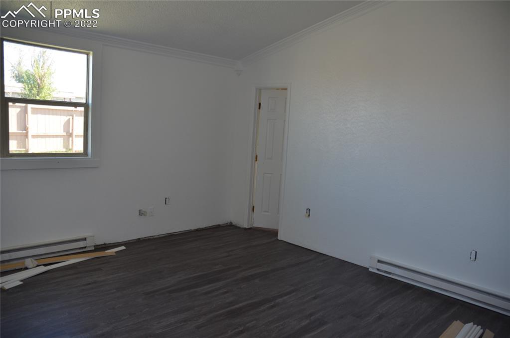 9456 McClelland Road Calhan, CO 80808 - Photo 10 of 31 an empty room with wooden floor and windows
