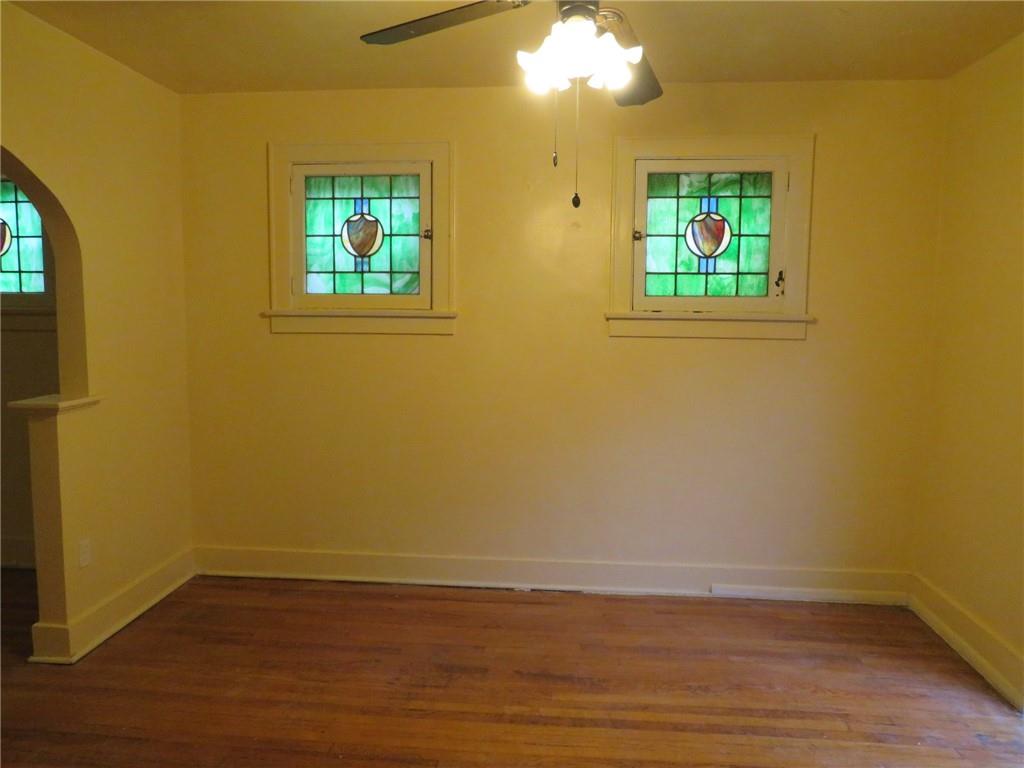 423 Braddock Road Pittsburgh, PA 15221 - Photo 9 of 36 a view of empty room with wooden floor and fan