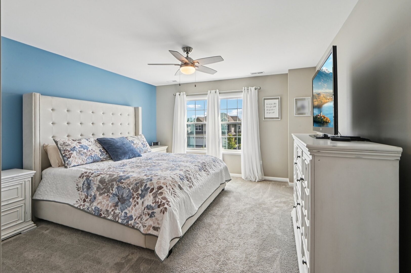 24734 South Dart Road Manhattan, IL 60442 - Photo 11 of 29 a spacious bedroom with a large bed and a chandelier