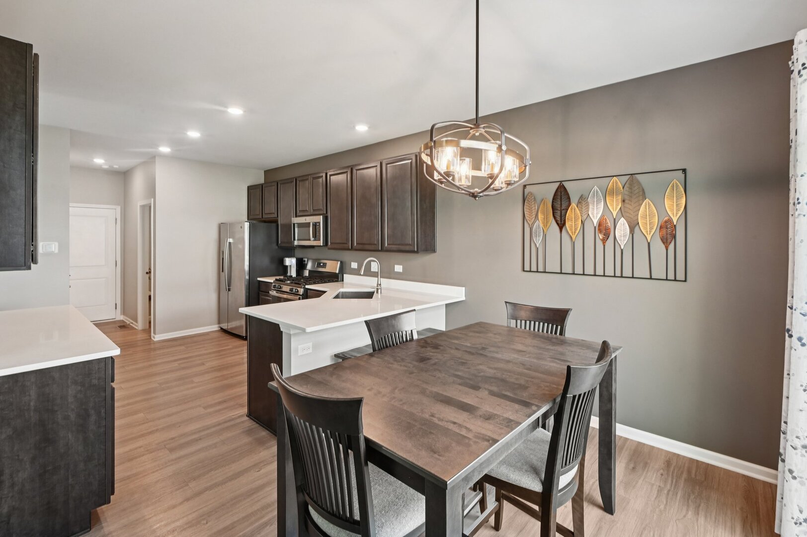 24734 South Dart Road Manhattan, IL 60442 - Photo 7 of 29 a view of a dining room with furniture wooden floor and chandelier