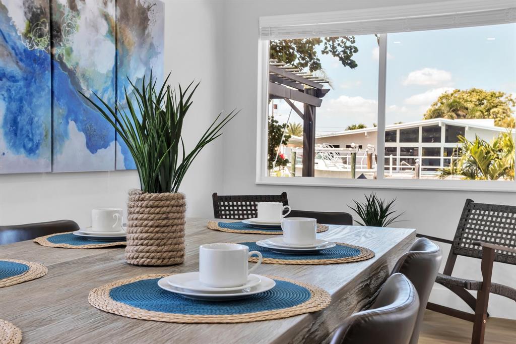 421 Southeast 14th Avenue Pompano Beach, FL 33060 - Photo 21 of 31 a view of a dining room with furniture a potted plant and wooden floor