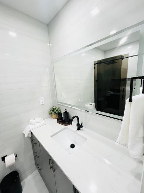 421 Southeast 14th Avenue Pompano Beach, FL 33060 - Photo 22 of 31 a bathroom with a double vanity sink and mirror