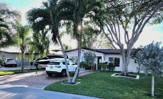 a view of a house with backyard porch and sitting area