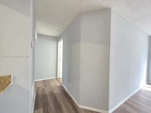a view of hallway with wooden floor