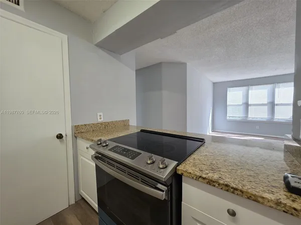 a stove top oven sitting inside of a kitchen