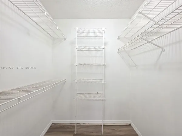 a view of walk in closet with empty racks