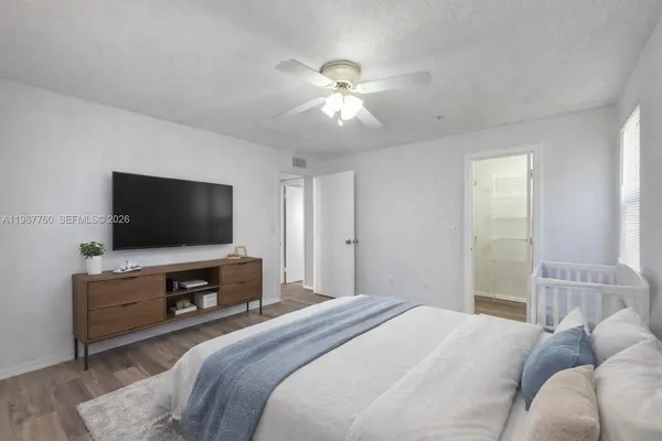 a bedroom with a bed and a flat screen tv