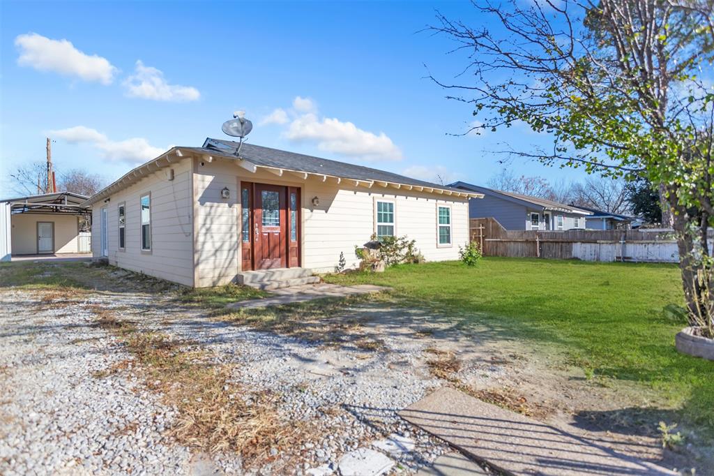 8115 Goldfield Drive Dallas, TX 75217 - Photo 1 of 16 a front view of a house with garden