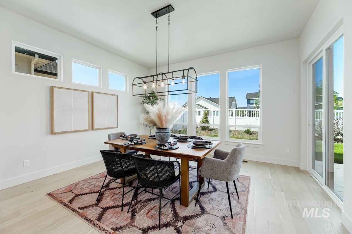 13265 North Spring Creek Way Boise, ID 83714 - Photo 10 of 35 Dining room with light wood-type flooring and suspended lighting