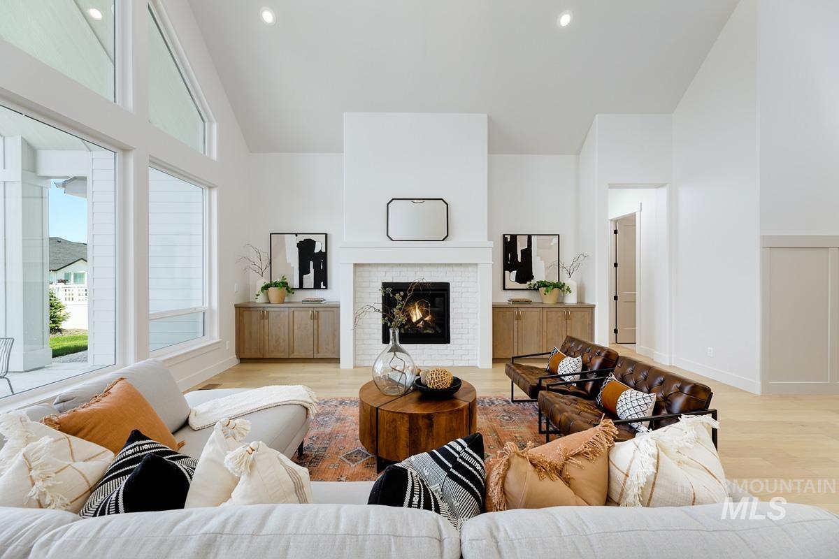 13265 North Spring Creek Way Boise, ID 83714 - Photo 5 of 35 Living area featuring light wood-type flooring, a brick fireplace, vaulted ceiling, and recessed lighting