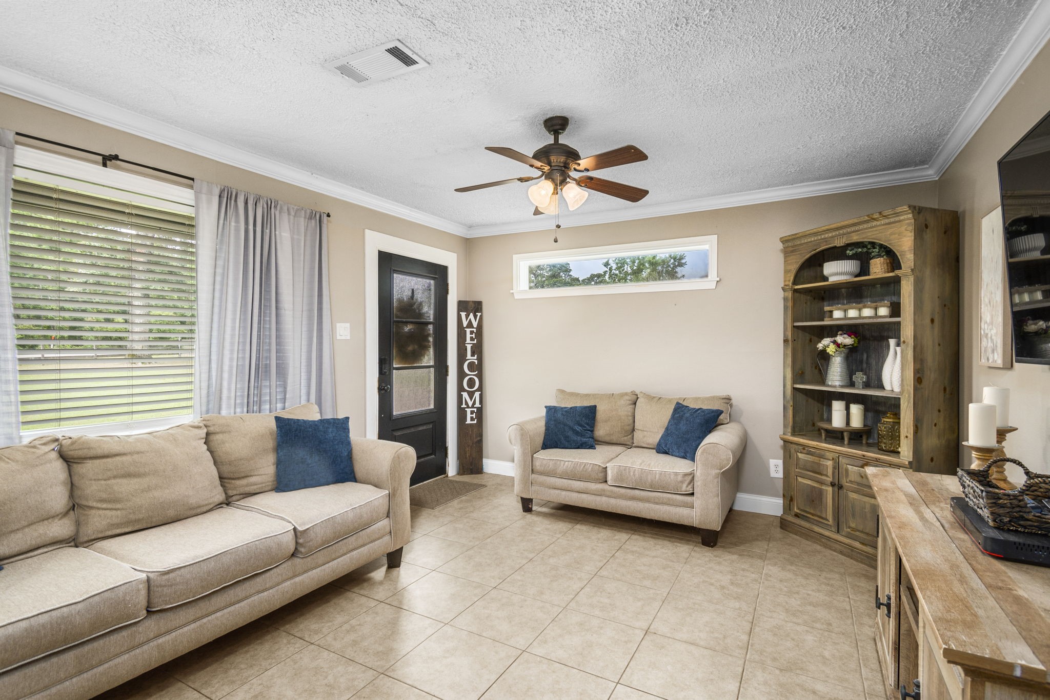 25311 Hardin Store Road Pinehurst, TX 77362 - Photo 6 of 39 a living room with furniture and a large window