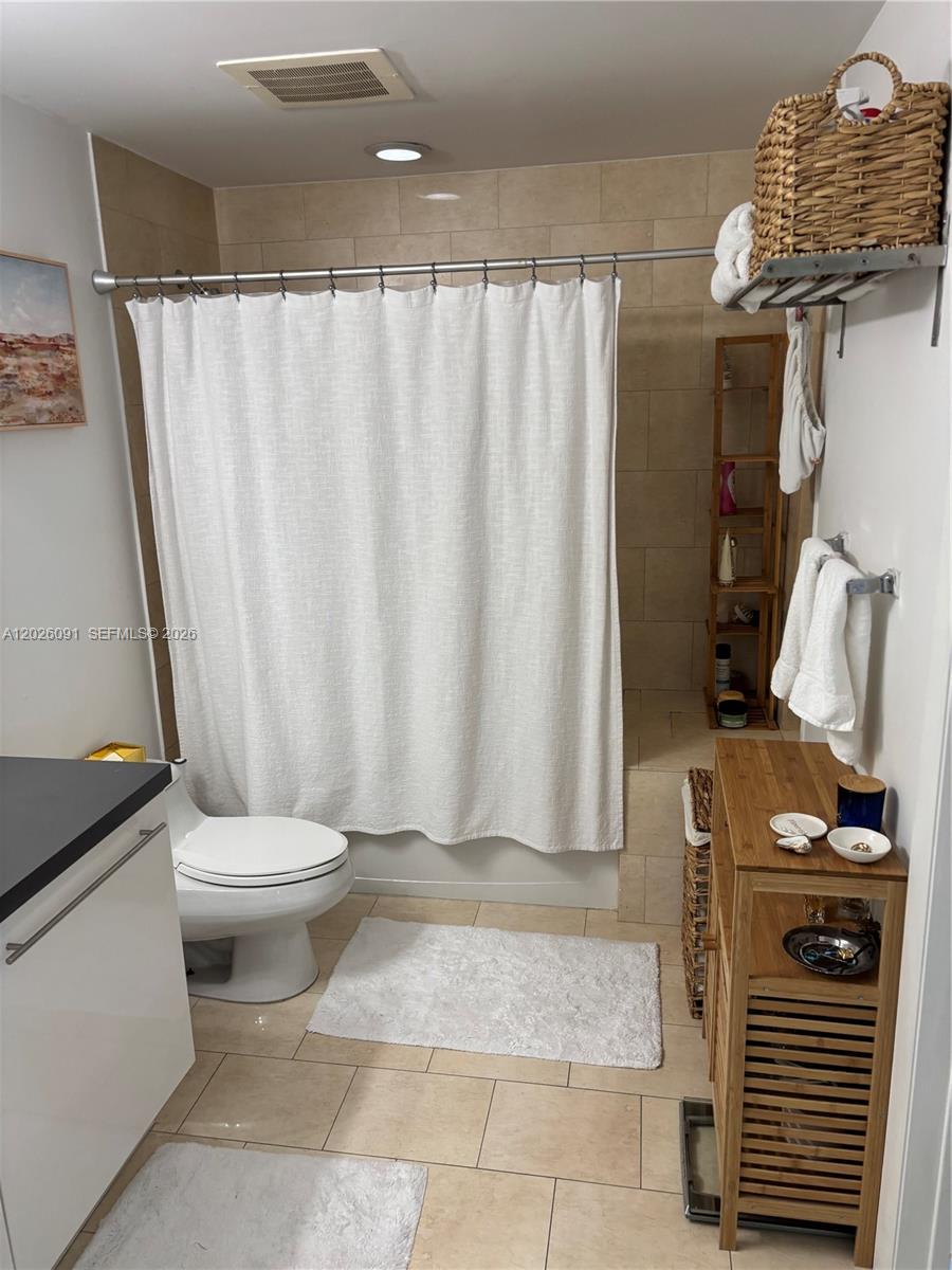 90 Southwest 3rd Street, Unit 1705 Miami, FL 33130 - Photo 11 of 33 a bathroom with a shower curtain and sink
