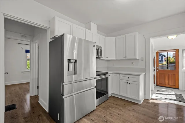 a kitchen with stainless steel appliances granite countertop a refrigerator and a sink