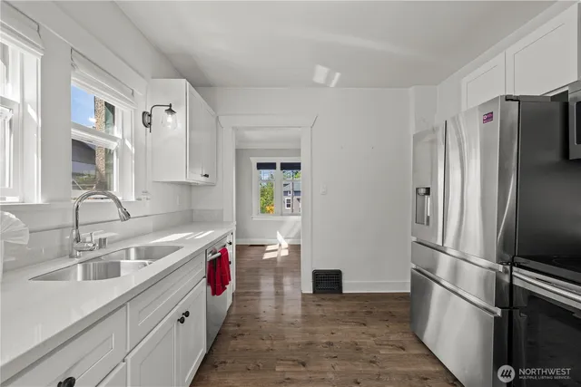 a kitchen with stainless steel appliances granite countertop a refrigerator and a sink
