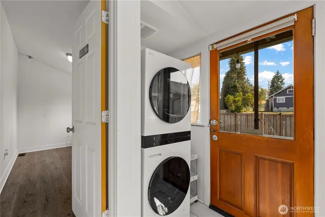 a view of a bedroom with washer and dryer