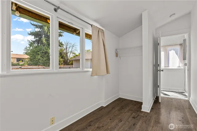a view of an entryway with wooden floor and door