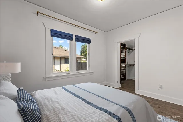 a bedroom with a bed and a window