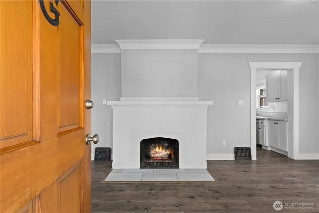 a living room with a fireplace furniture and a wooden floor