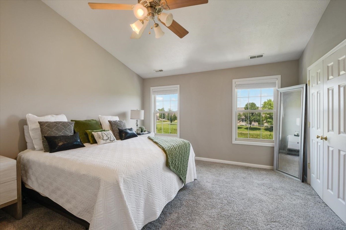 4622 Copper Ridge Road, Unit 4622 Champaign, IL 61822 - Photo 11 of 25 a bedroom with a large bed and a chandelier fan