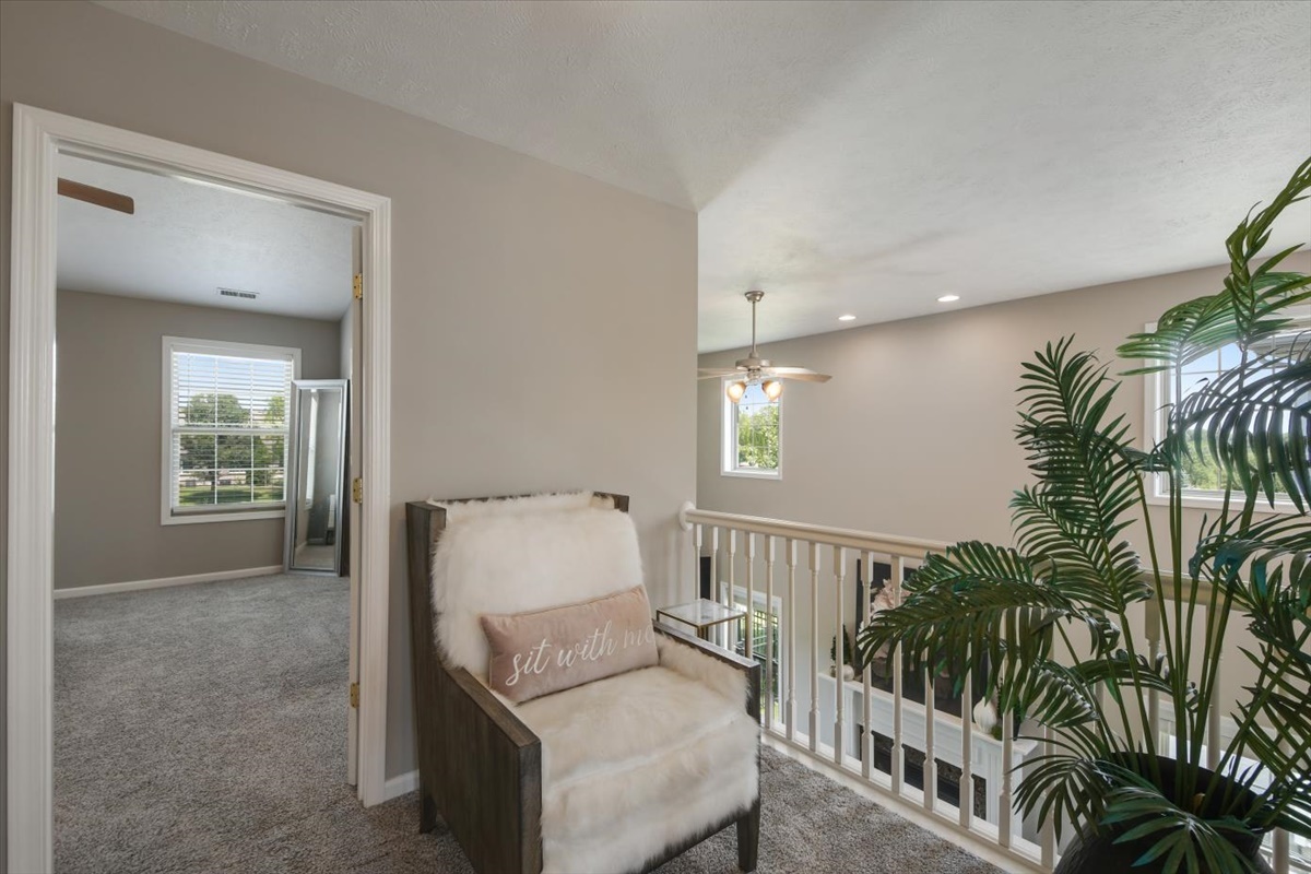 4622 Copper Ridge Road, Unit 4622 Champaign, IL 61822 - Photo 12 of 25 a living room with furniture and a potted plant