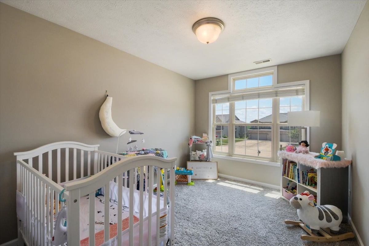 4622 Copper Ridge Road, Unit 4622 Champaign, IL 61822 - Photo 16 of 25 a bedroom with furniture a window and a chandelier