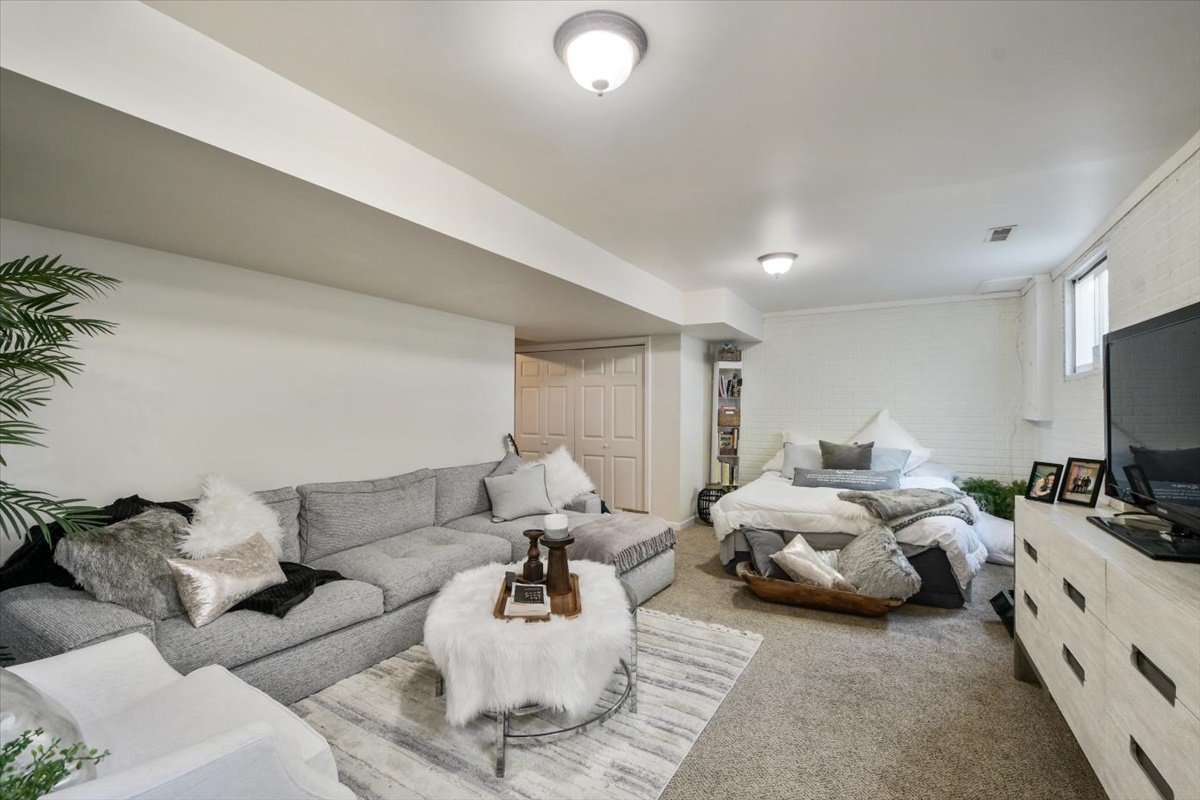 4622 Copper Ridge Road, Unit 4622 Champaign, IL 61822 - Photo 19 of 25 a living room with furniture a flat screen tv and white walls