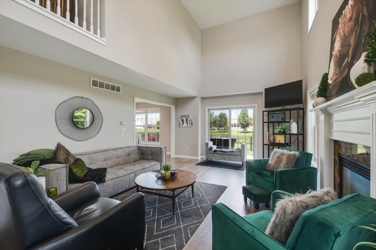 4622 Copper Ridge Road, Unit 4622 Champaign, IL 61822 - Photo 2 of 25 a living room with furniture and a fireplace