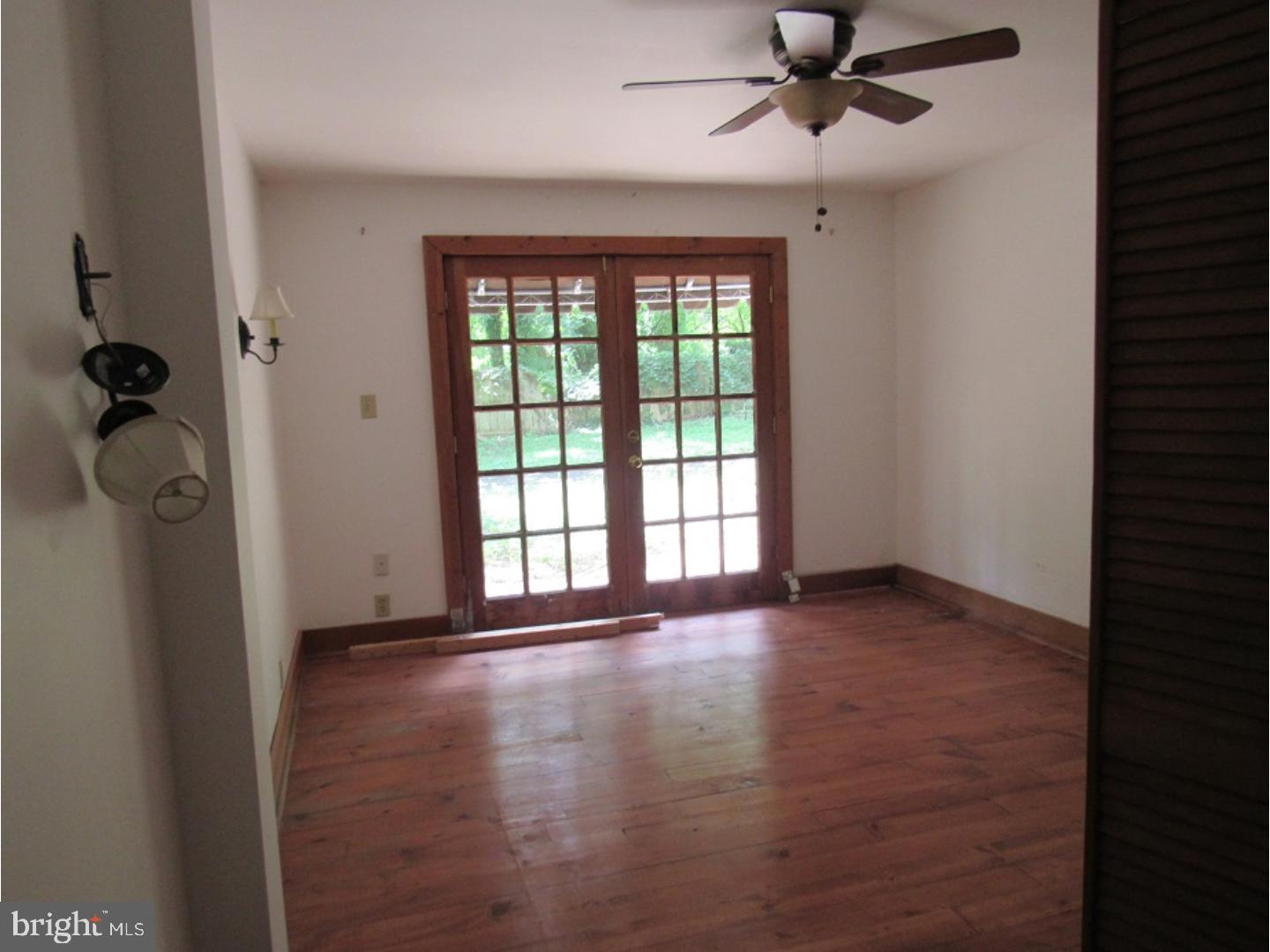 433 Bridgeboro Road Moorestown, NJ 08057 - Photo 15 of 24 a view of an empty room with a window and wooden floor