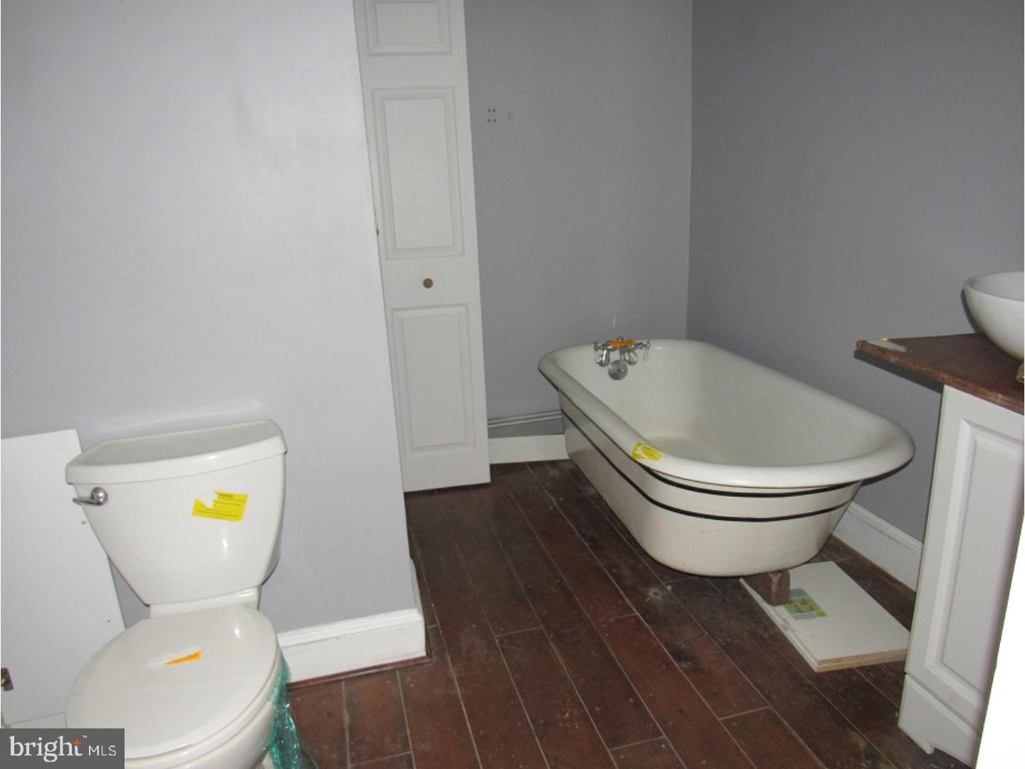 433 Bridgeboro Road Moorestown, NJ 08057 - Photo 16 of 24 a white toilet sitting next to a bathroom sink and a wooden floor
