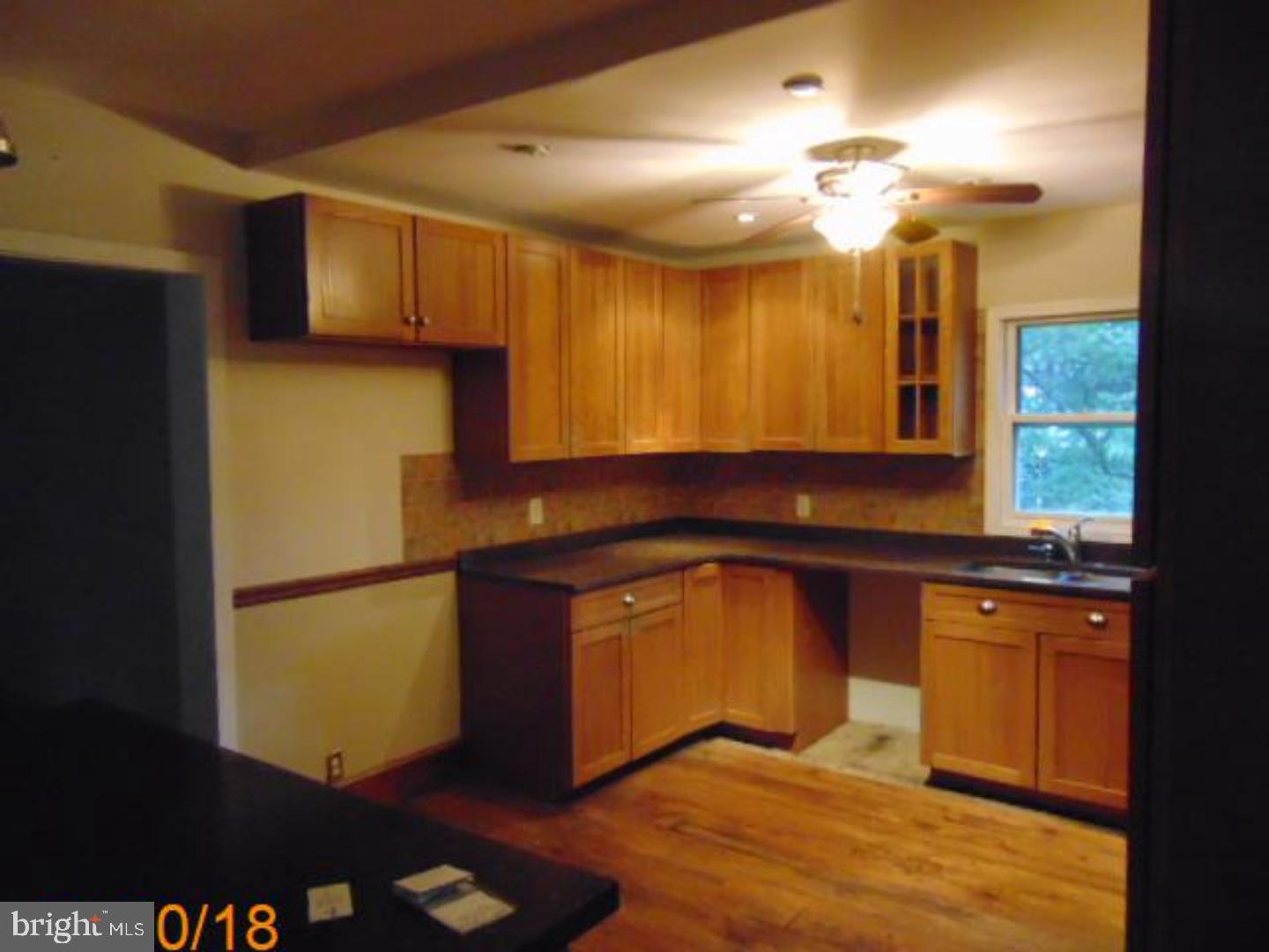 433 Bridgeboro Road Moorestown, NJ 08057 - Photo 24 of 24 a kitchen with stainless steel appliances granite countertop a refrigerator a sink dishwasher a stove and a dining table with wooden floor