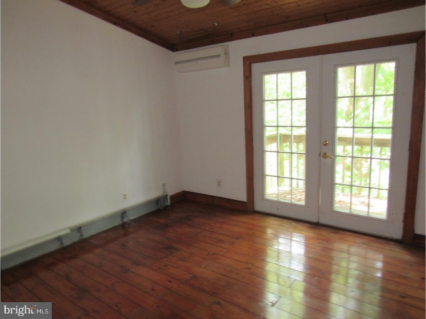 433 Bridgeboro Road Moorestown, NJ 08057 - Photo 6 of 24 an empty room with wooden floor and windows