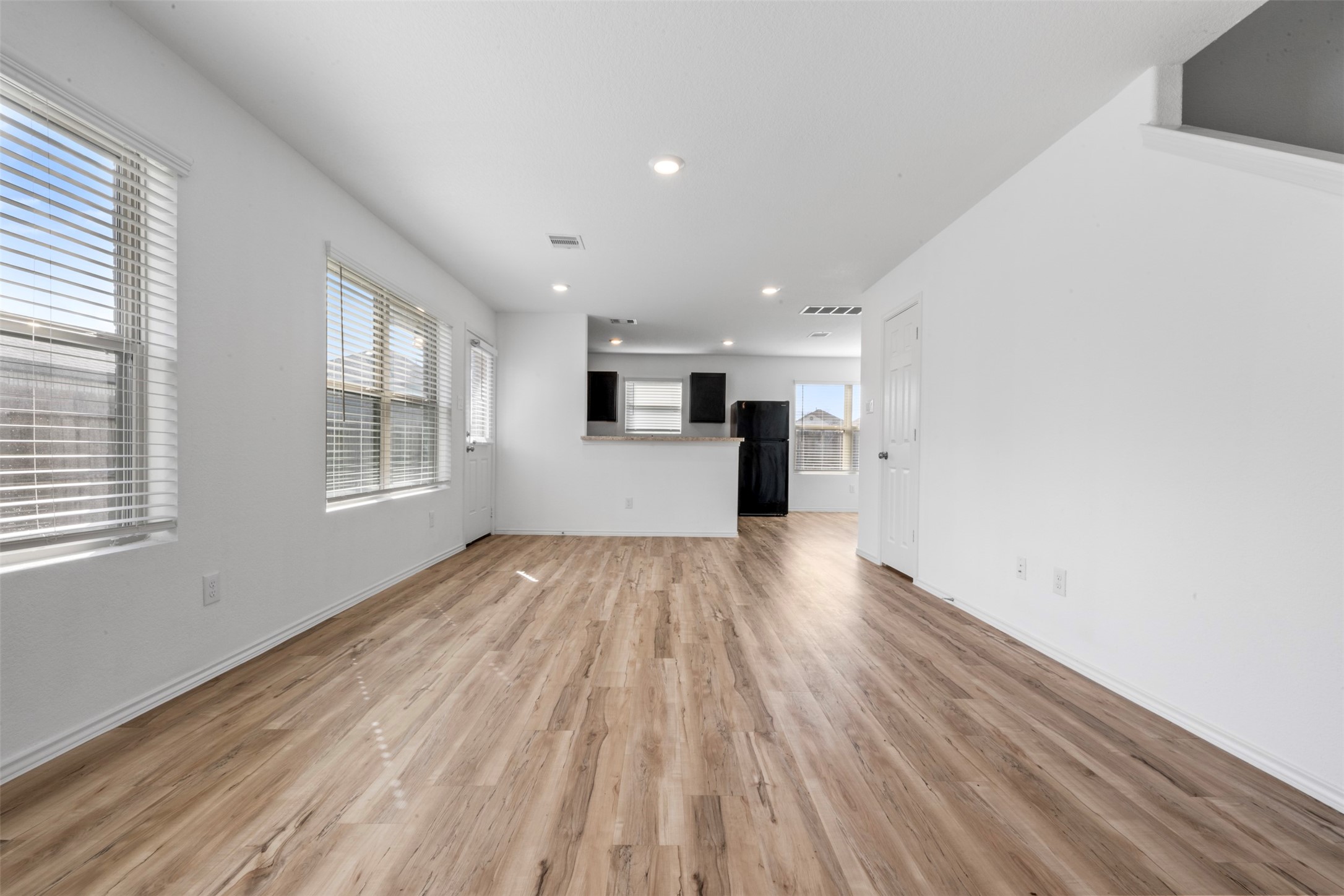 14538 Broadbury Pond Road Rosharon, TX 77583 - Photo 4 of 25 a view of empty room with wooden floor and window