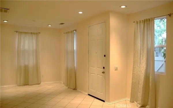 a view of a hallway with wooden floor and closet area