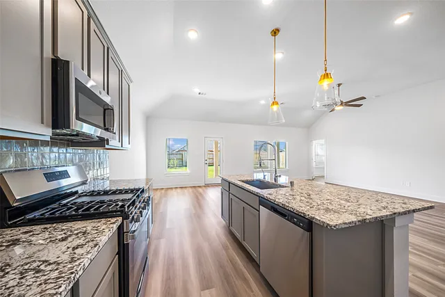 a kitchen with a sink stove and refrigerator