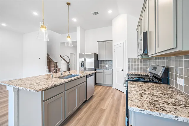 an empty room with wooden floor closet and windows