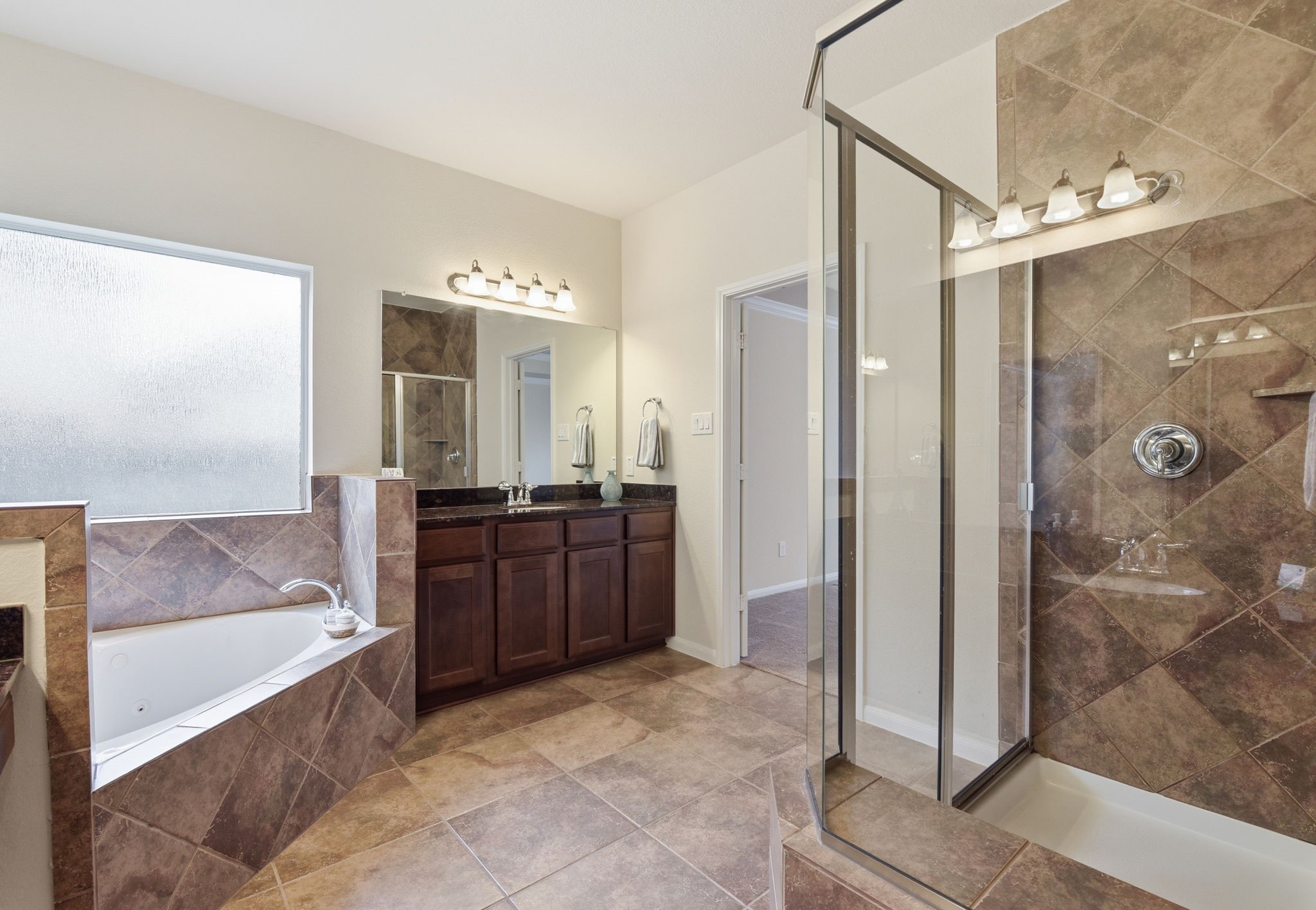 3301 Remington Rise Lane Katy, TX 77494 - Photo 26 of 50 a spacious bathroom with a mirror a shower and bathtub