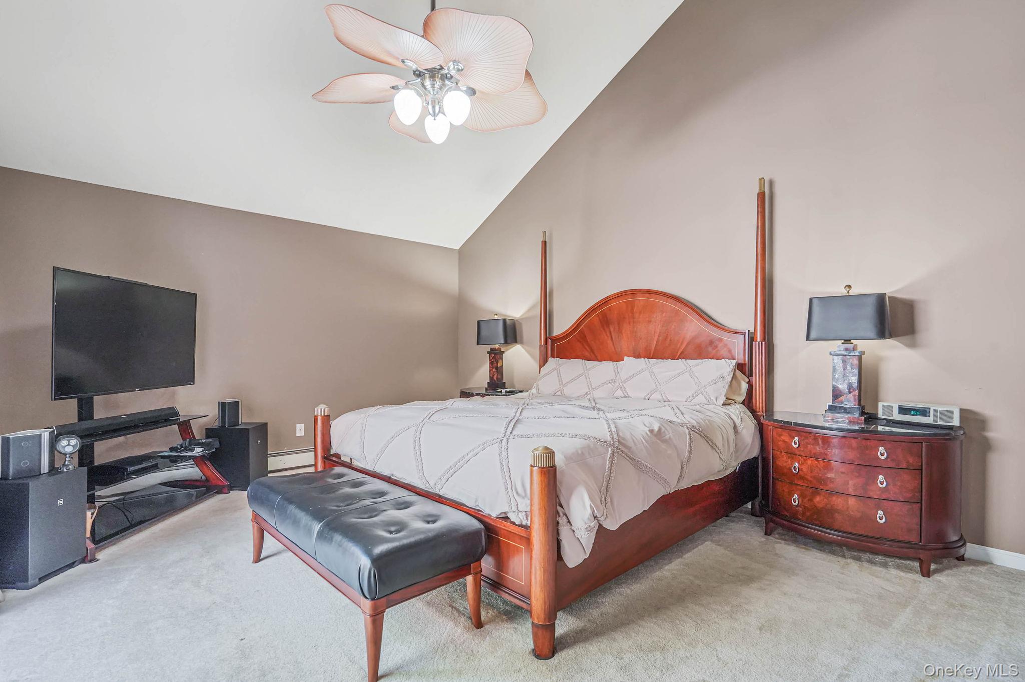 318 Sheep Pasture Road East Setauket, NY 11733 - Photo 16 of 45 a bedroom with a bed and a flat screen tv