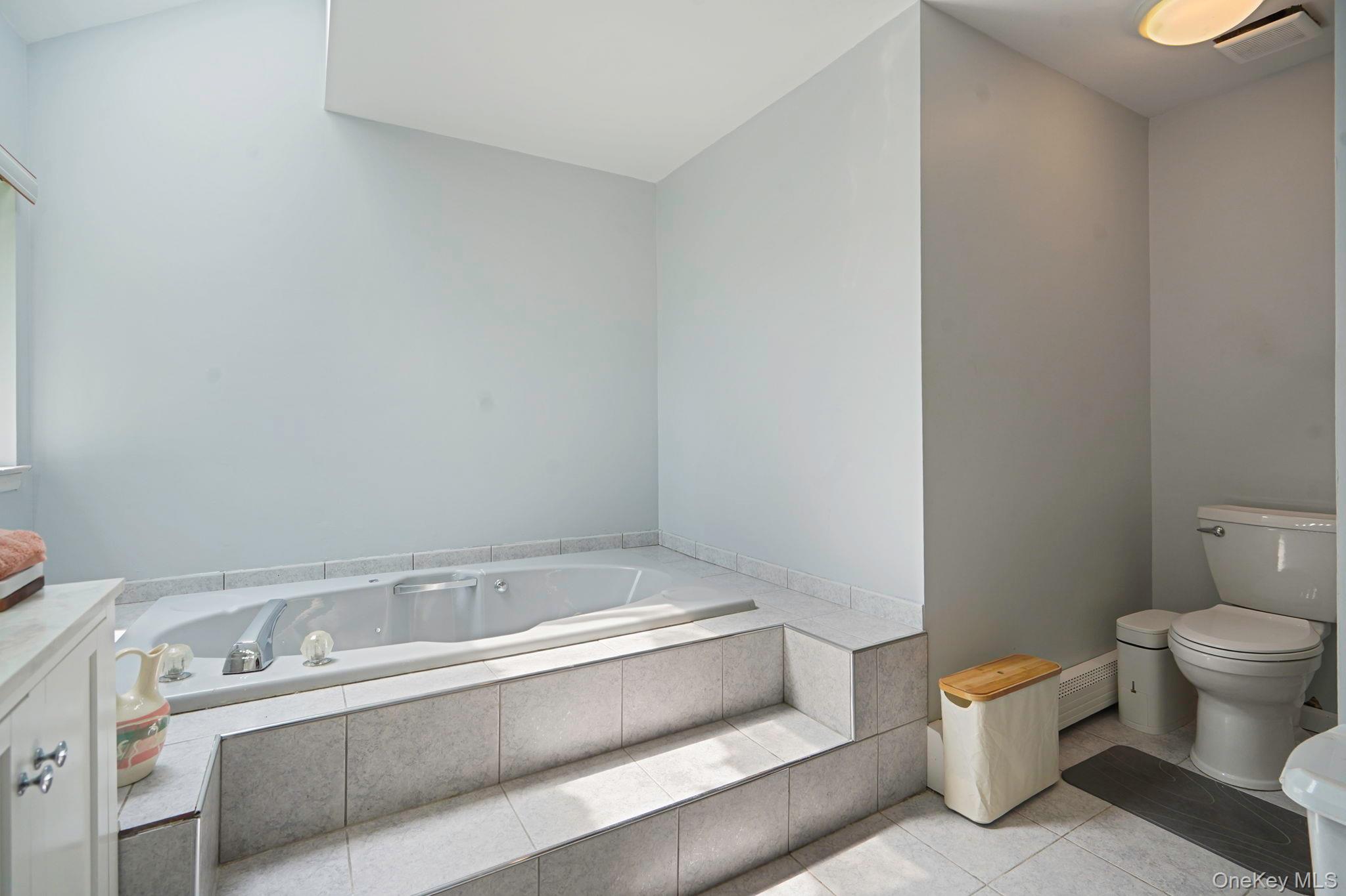 318 Sheep Pasture Road East Setauket, NY 11733 - Photo 19 of 45 a bathroom with a sink and a toilet
