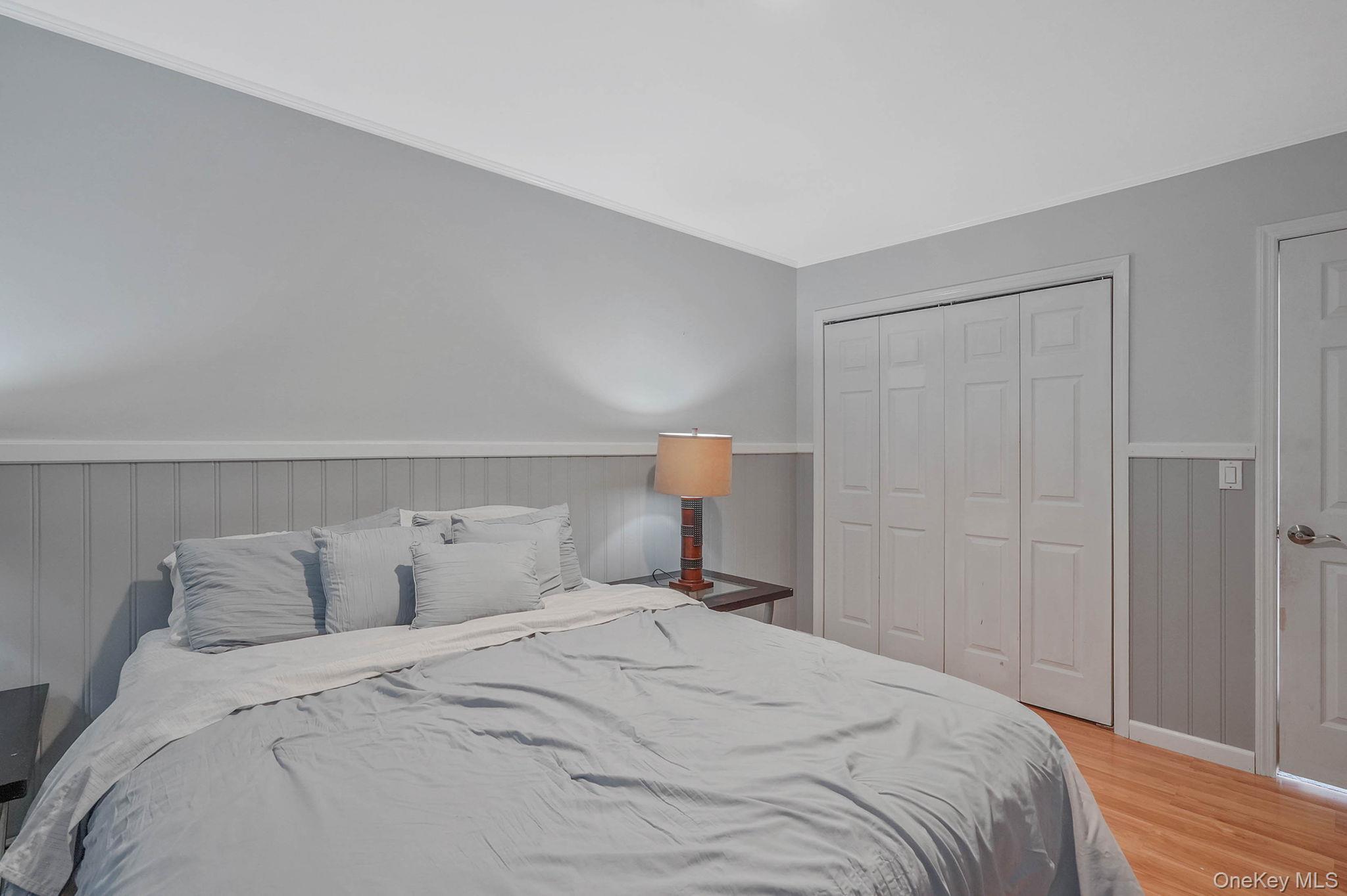 318 Sheep Pasture Road East Setauket, NY 11733 - Photo 27 of 45 a bedroom with a bed and a night stand