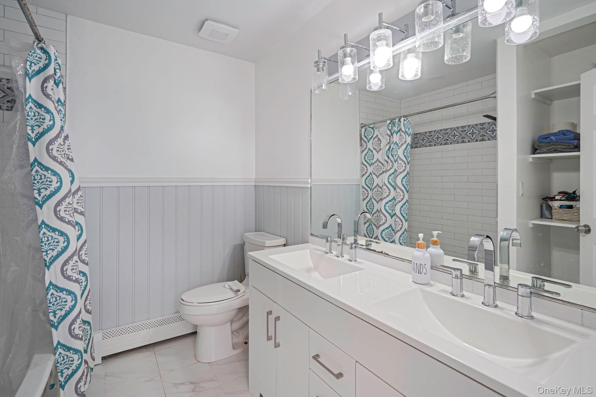 318 Sheep Pasture Road East Setauket, NY 11733 - Photo 29 of 45 a bathroom with a sink a toilet and a mirror